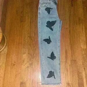 Adika denim jeans in a size medium with butterfly design.